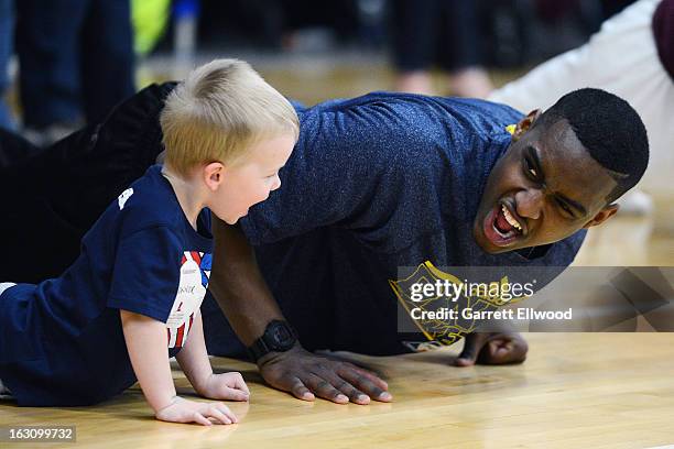 Quincy Miller of the Denver Nuggets does push ups with a child during a Team Fit Clinic with patients / siblings / supporters from St. Jude...