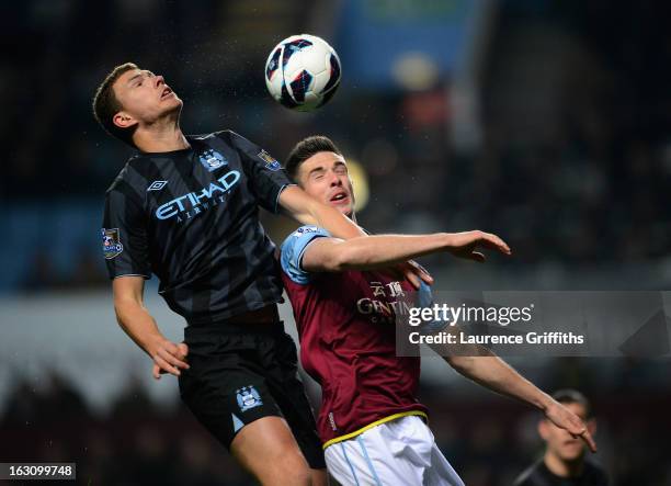 Edin Dzeko of Manchester City battles with Ciaran Clark of Aston Villa during the Barclays Premier League match between Aston Villa and Manchester...