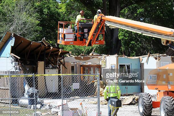 Workers remove belongings from the home where a sinkhole swallowed Jeffrey Bush on March 4, 2013 in Seffner, Florida. Jeff Bush, presumed dead after...