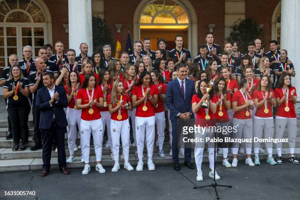 Football player Ivana Andrés holds the Women's World Cup trophy as Spanish Prime Minister Pedro Sanchez receives the Spanish women’s national...