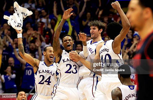 Travis Releford, Ben McLemore, Jeff Withey, and Kevin Young of the Kansas Jayhawks celebrate after Withey hit a three-pointer during the game against...