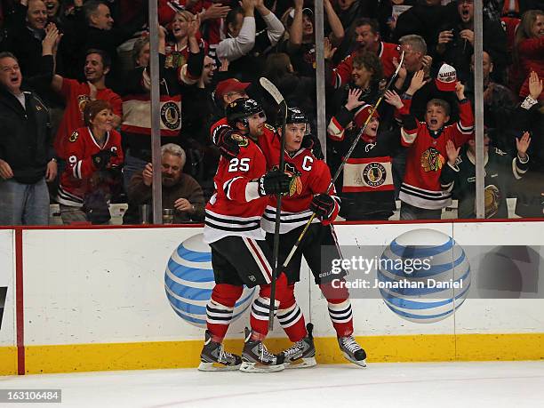 Viktor Stalberg and Jonathan Toews of the Chicago Blackhawks celebrate a win over the Columbus Blue Jackets at the United Center on March 1, 2013 in...