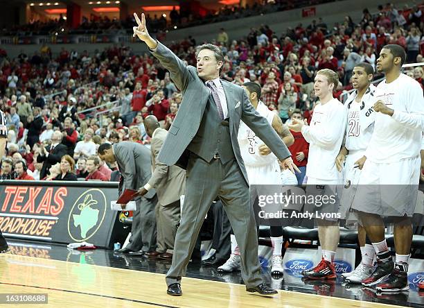 Rick Pitino the head coach of the Louisville Cardinals gives instructions to his team during the game against the Cincinnati Bearcats at KFC YUM!...