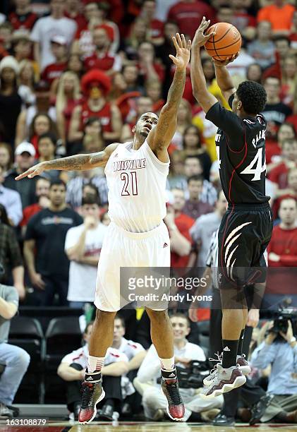 Chane Behanan of the Louisville Cardinals defends the shot of JaQuon Parker of the Cincinnati Bearcats during the game at KFC YUM! Center on March 4,...
