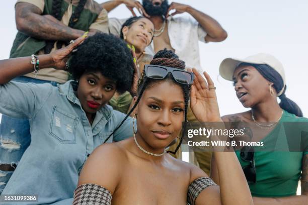 african american women posing for photo at rooftop party - cadena de oro fotografías e imágenes de stock