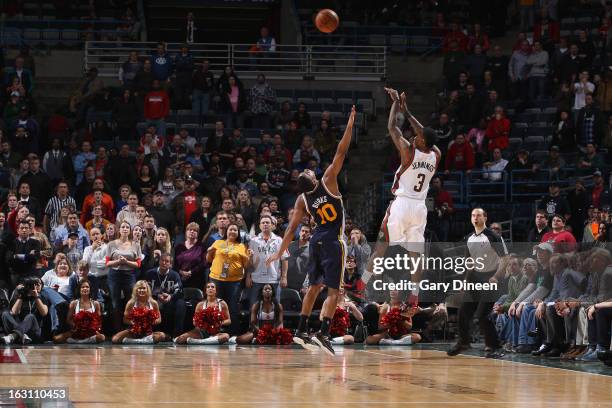 Brandon Jennings of the Milwaukee Bucks shoots a three-pointer against Alec Burks of the Utah Jazz to tie the game with 8.4 seconds remaining in...