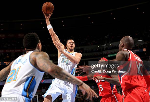 JaVale McGee of the Denver Nuggets lays up a shot against the Atlanta Hawks at the Pepsi Center on March 4, 2013 in Denver, Colorado. The Nuggets...