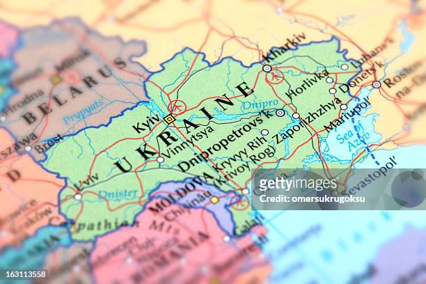 map of green ukraine on a globe - ukraine stock pictures, royalty-free photos & images