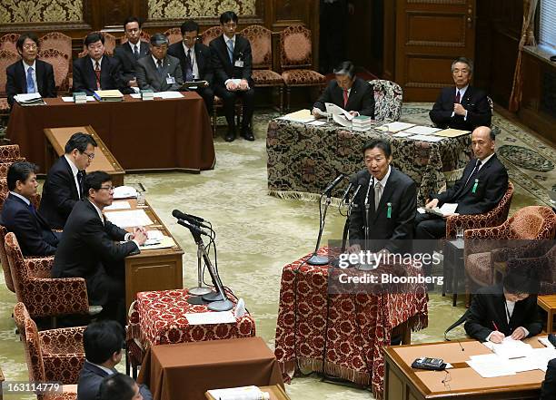 Kikuo Iwata, professor of economics at Gakushuin University and nominee for deputy governor of the Bank of Japan , center standing, speaks as Hiroshi...