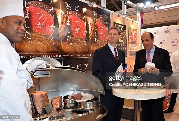 Ambassador to Japan John Roos and Gregory Hanes , assistant vice president of the US Meat Export Federation taste US beef at the annual "Foodex" food...