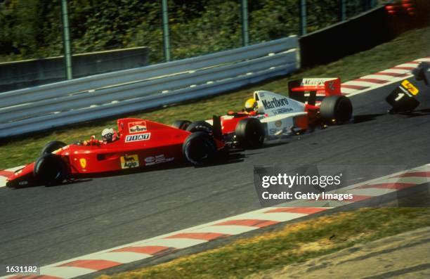 Fiat Ferrari driver Alain Prost of France and McLaren Honda driver Ayrton Senna of Brazil crash during the Japanese Grand Prix at the Suzuka circuit...