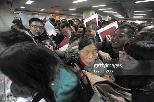 People crowd into the Nanjing Municipal Real Estate Trading Centre to sell their second-hand houses before a tax policy change on March 4, 2013 in...