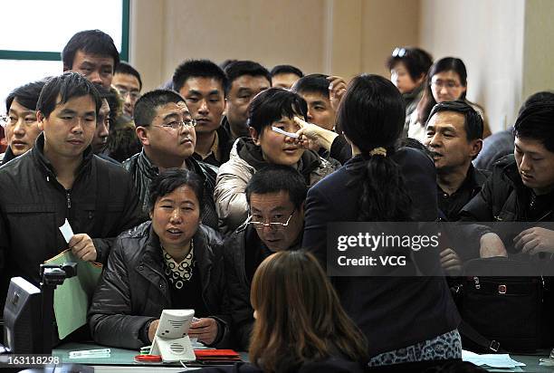 People crowd into the Nanjing Municipal Real Estate Trading Centre to sell their second-hand houses before a tax policy change on March 4, 2013 in...