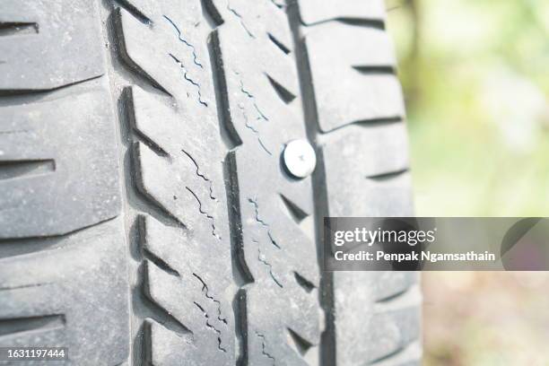 nail in tire - screw stock pictures, royalty-free photos & images