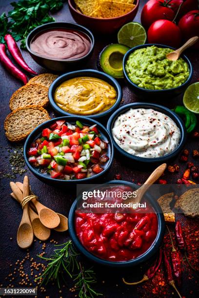 set of various dipping sauces shot from above on dark table - barbeque sauce stock pictures, royalty-free photos & images