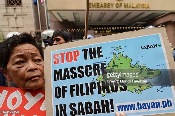 Protestors hold a rally outside the Malaysian embassy in the financial district of Makati on March 5, 2013 in Manila, Philippines. The protestors...