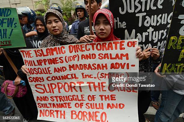 Protestors hold a rally outside the Malaysian embassy in the financial district of Makati on March 5, 2013 in Manila, Philippines. The protestors...