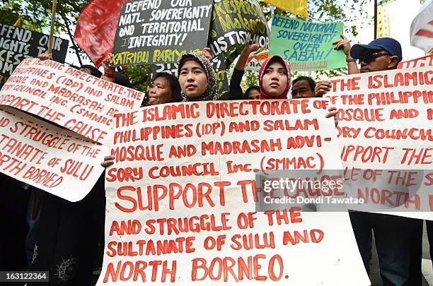 Protestors hold a rally outside the Malaysian embassy in the financial district of Makati on March 5, 2013 in Manila, Philippines. The protestors...