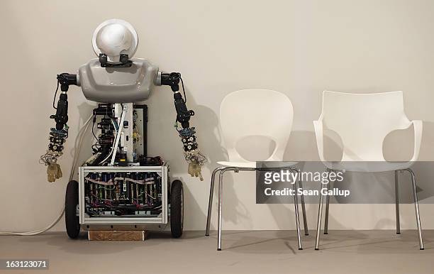 Robot rests next to empty chairs at the Poland country stand at the 2013 CeBIT technology trade fair on March 5, 2013 in Hanover, Germany. CeBIT will...