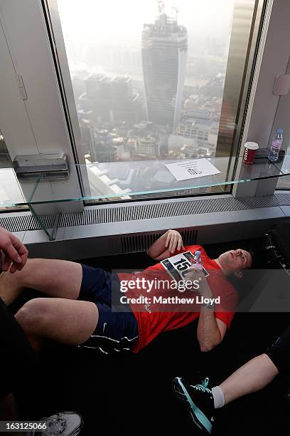Runners react after reaching the finish of the Vertical Rush event in the Tower 42 skyscraper on March 5, 2013 in London, England. More than a...