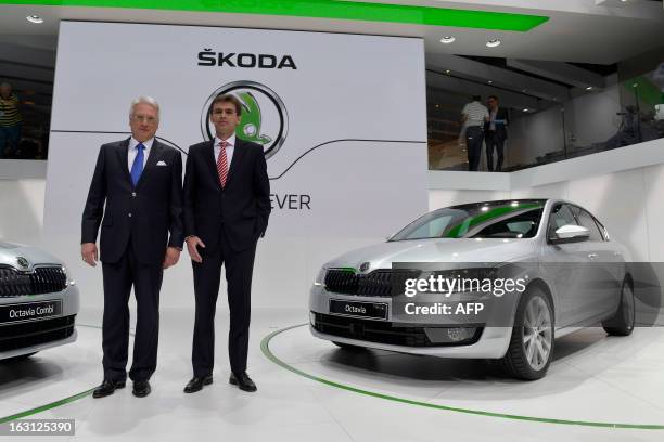 Skoda's CEO Winfried Vahland and board member Franc Welsch pose with the new Skoda Octavia displayed in World premiere at the Geneva International...