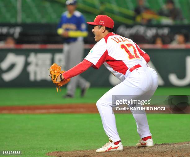 Chinese pitcher Lu Jiangang reacts as he celebrates his team's win over Brazil at the last inning of the first-round Pool A game in the World...