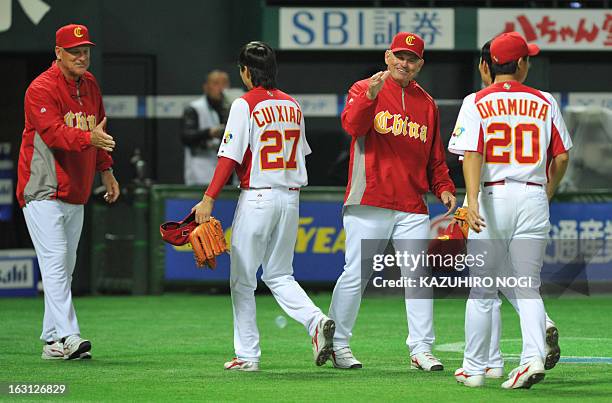 China's manager John McLaren greets players following their win over Brazil at the last inning of the first-round Pool A game in the World Baseball...