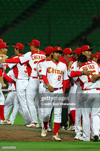 Catcher Weiqiang Meng of China celebrates winning with teammates during the World Baseball Classic First Round Group A game between China and Brazil...