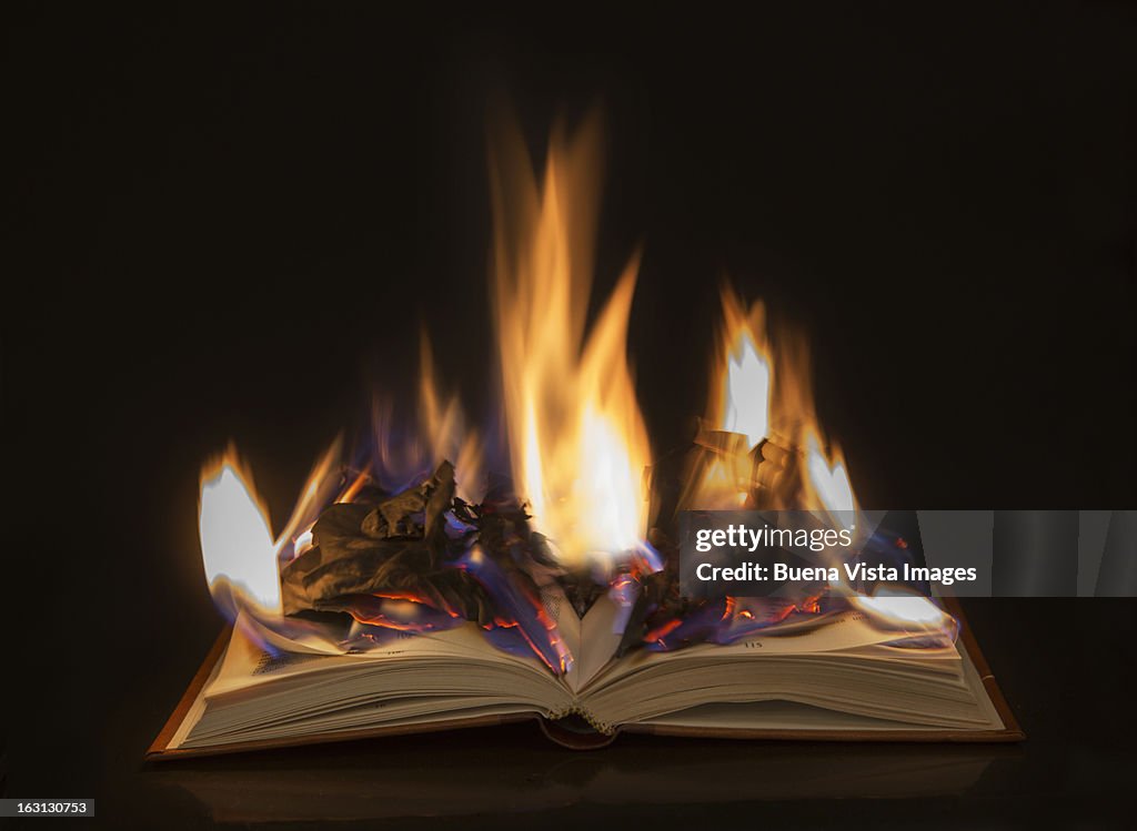 Open book with burning pages