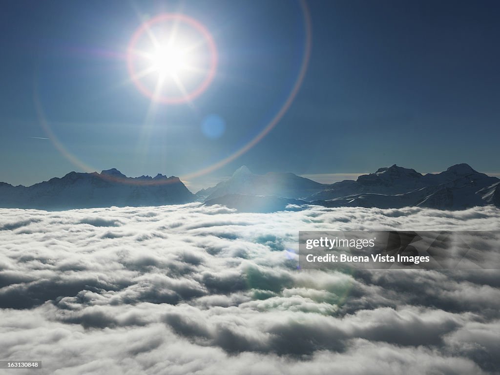 Sunshine over mountains  emerging from  fog