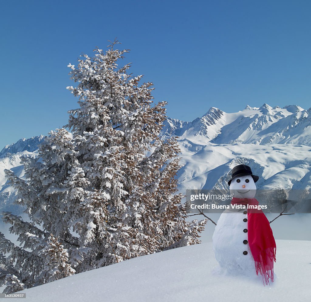 Snowman in snowy mountains.