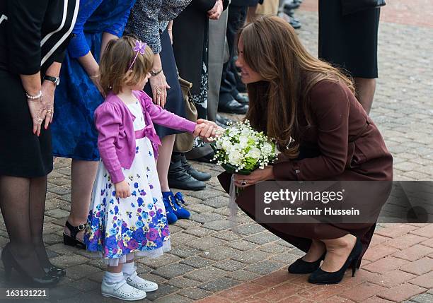 Catherine, Duchess of Cambridge meets a girl as she visits the Fishing Heritage Centre during an official visit to Grimsby on March 5, 2013 in...