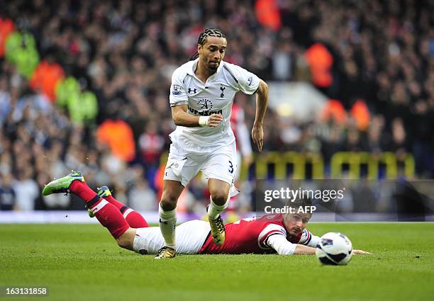 Arsenal's French striker Olivier Giroud lies on the ground after vieing with Tottenham Hotspur's French-born Cameroonian defender Benoit Assou-Ekotto...