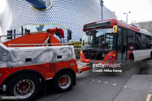 Broken down bus being towed away by a large vehicle recovery truck on 7th August 2023 in Birmingham, United Kingdom.
