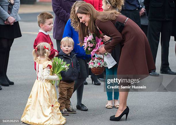 Catherine, Duchess of Cambridge meets children as she visits Humberside Fire and Rescue during an official visit to Grimsby on March 5, 2013 in...