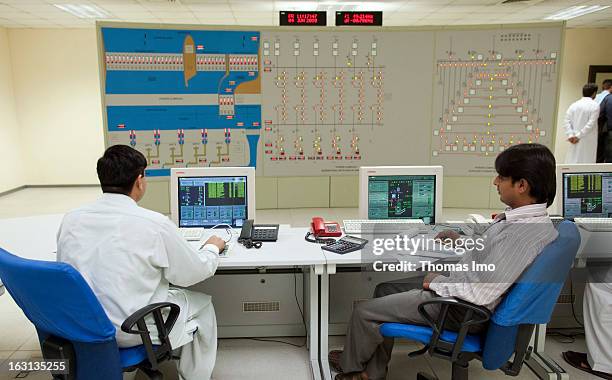 Workers sitting in the control room of the hydroelectric power station.