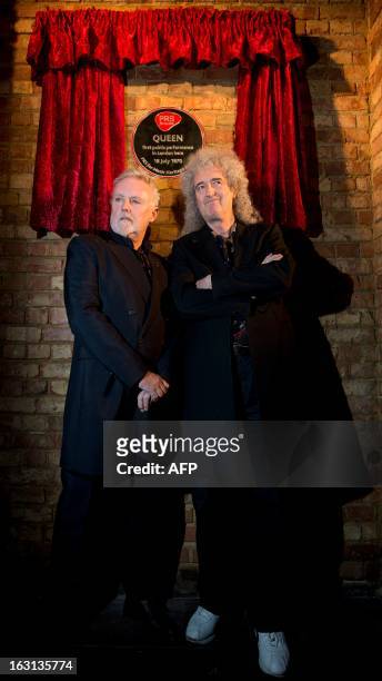 Members of British rock band Queen, Roger Taylor and Brian May , pose with a plaque following a ceremony in which Queen were awarded the PRS for...