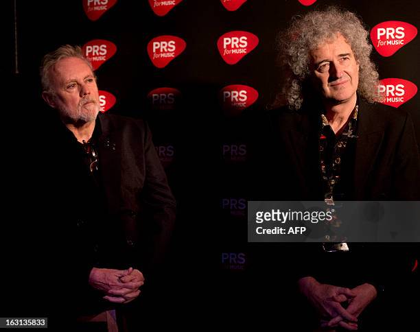 Members of British rock band Queen Brian May and Roger Taylor attend a ceremony in which Queen were awarded the PRS for Music Heritage Award at...