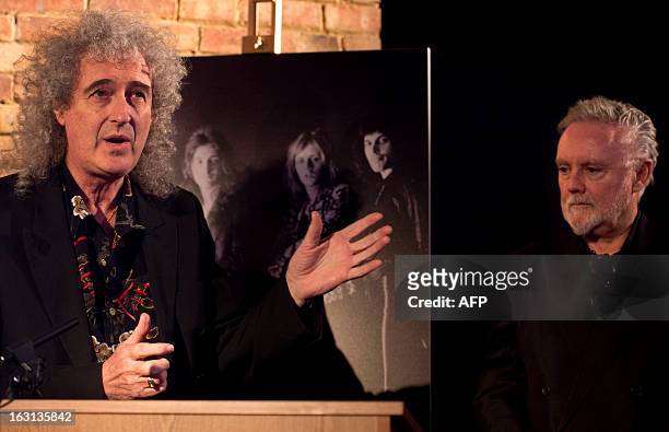 Member of British rock band Queen, Brian May , talks next to bandmate Roger Taylor during a ceremony in which Queen were awarded the PRS for Music...