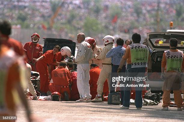 The Medical team surrounds Williams Renault driver Ayrton Senna of Brazil after Senna crashes during the San Marino Grand Prix at the Imola circuit...