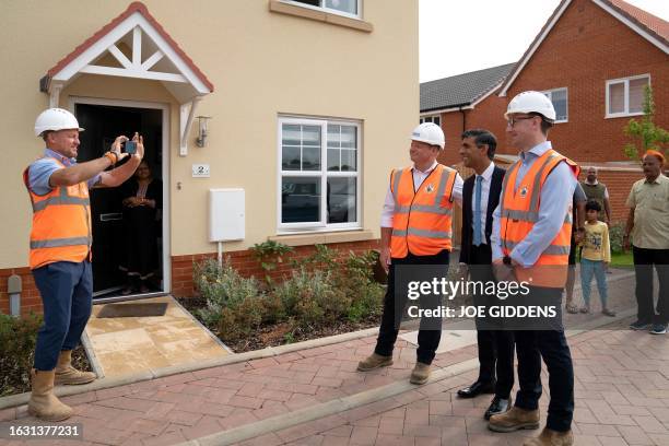 Britain's Prime Minister Rishi Sunak poses for a picture during a visit to the Taylor Wimpey Heather Gardens housing development in Norwich on August...