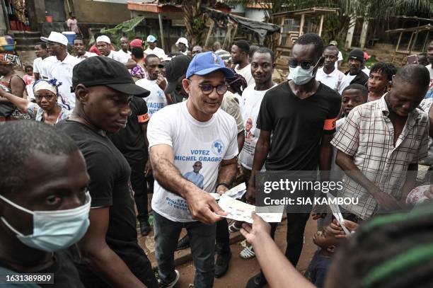 Michel Gbagbo , the son of the former Ivorian president Laurent Gbagbo, is accompanied by his campaign staff in an alley of Yopougon a popular...