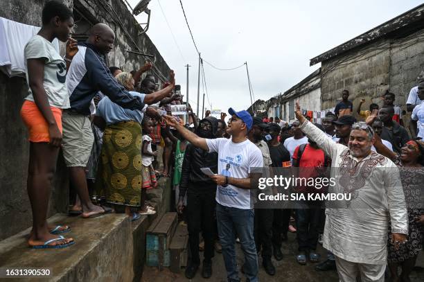 Michel Gbagbo , the son of the former Ivorian president Laurent Gbagbo, is accompanied by his campaign staff in an alley of Yopougon a popular...