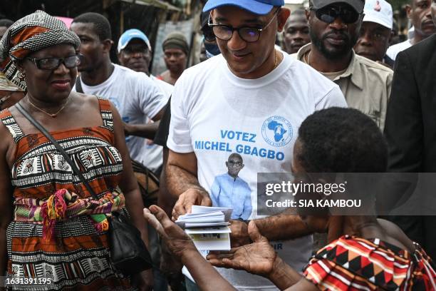 Michel Gbagbo , the son of the former Ivorian president Laurent Gbagbo, is accompanied by his campaign staff in an alley of Yopougon a popular...