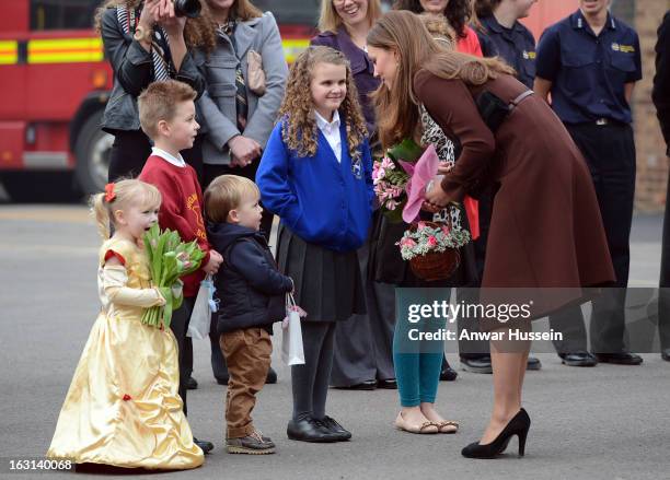 Catherine, Duchess of Cambridge meets children as she visits Humberside Fire and Rescue during an official visit to Grimsby on March 5, 2013 in...