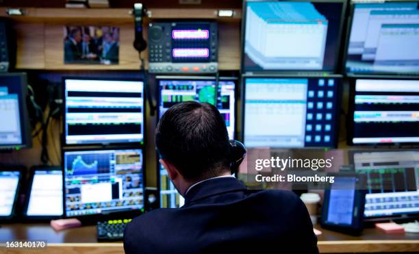 Trader works on the floor of the New York Stock Exchange in New York, U.S., on Tuesday, March 5, 2013. Stocks rallied, sending the Dow Jones...