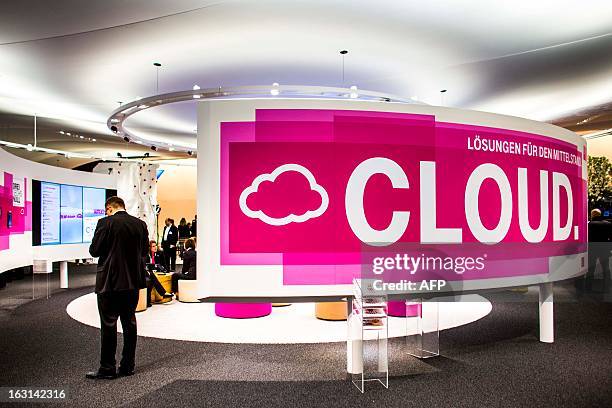 Person stands by a banner reading 'cloud' at the telecoms stand at the 2013 CeBIT technology trade fair on March 5, 2013 in Hanover, Germany. CeBIT...