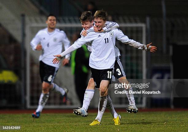 Porath Finn of Germany celebrates his team's third goal with team mate David Kammerbauer during the U16 international friendly match between Germany...