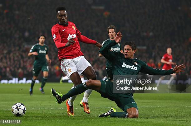 Danny Welbeck of Manchester United is challenged by Raphael Varane of Real Madrid during the UEFA Champions League Round of 16 Second leg match...