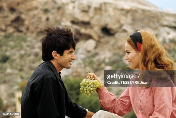 Shooting In Spain Of The Film 'L'Homme De Marrakech' By Jacques Deray. Dans un décor montagneux, Claudine AUGER, avec un bandeau, en chemisier tenant...